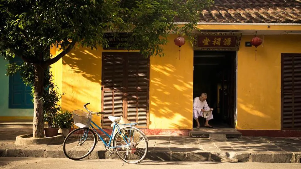Street with yellow walls and a bicycle, original image